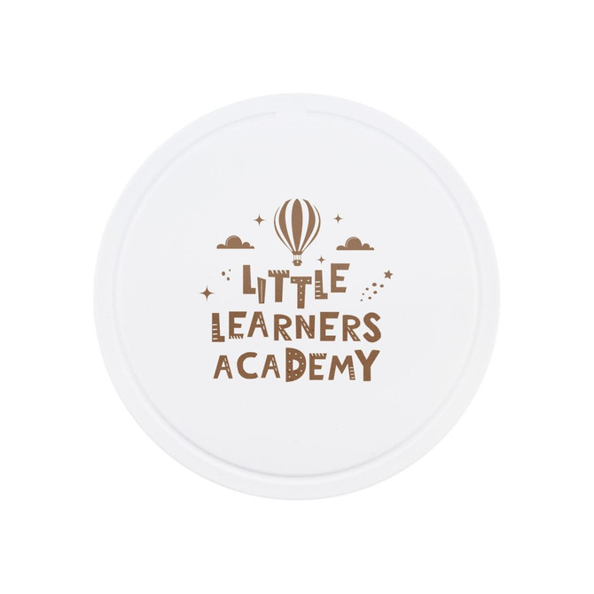 A round white promotional item featuring the text "Little Learners Academy" in brown with a hot air balloon and stars.