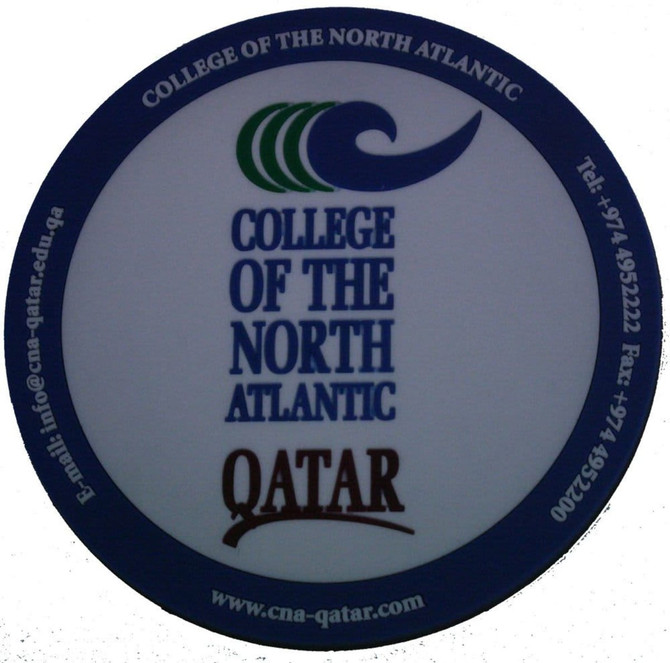 A round, white PVC coaster featuring a logo and text related to the College of the North Atlantic, Qatar.