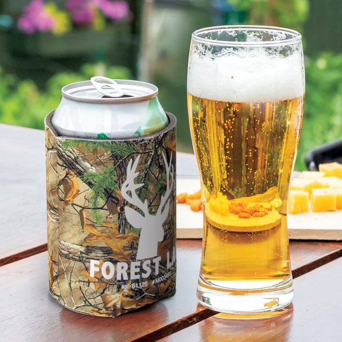 A drink bottle featuring a camouflage pattern, accompanied by a glass of beer with a foam head and snack items.