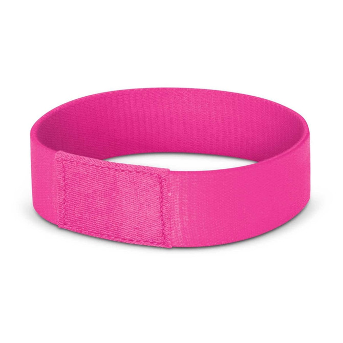 A bright pink wristband with a textured finish and a secure fastening. It features a logo or branding.