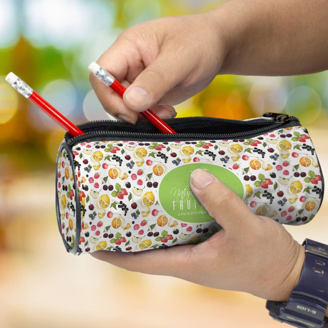 A pencil case featuring a vibrant fruit design, being held with two red pencils inside. It has a logo on the side.