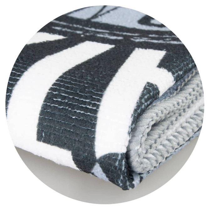 A folded sports towel in grey and white, featuring a patterned design and a logo.