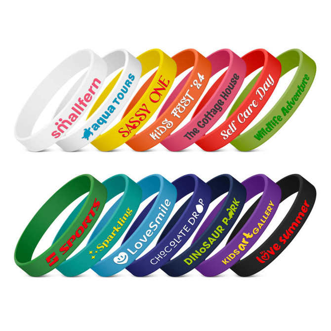 A collection of silicone wristbands in various colours, featuring embossed text and different designs.