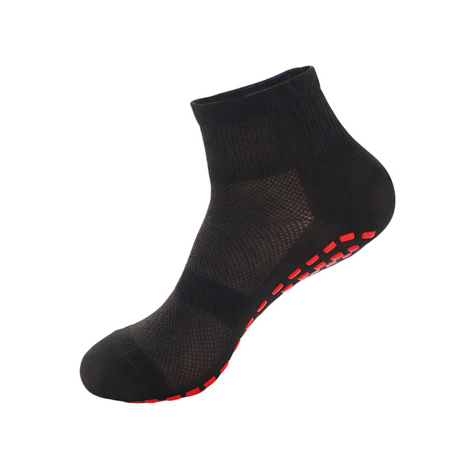 A pair of black crew socks with a red dotted sole and a mesh design. The socks also feature a logo.