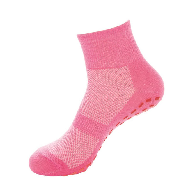 A pair of pink crew kids' gripper socks featuring a textured sole and ankle-height design.