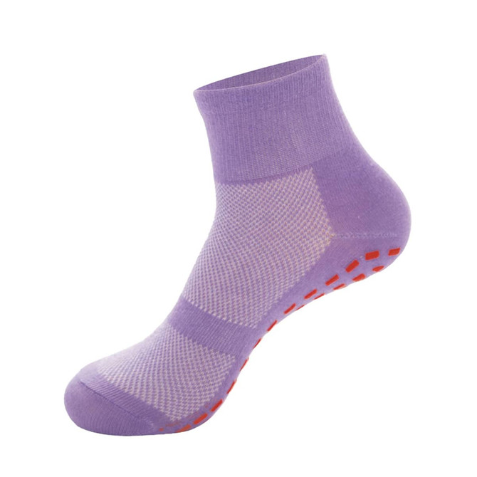 A pair of purple crew kids gripper socks with red non-slip dots on the sole and a mesh design.
