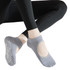 Open top yoga socks in grey featuring grip dots on the soles, accompanied by black leggings.