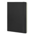 A large black soft cover notebook with an elastic band closure and a cream-coloured interior.