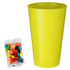 A bright yellow cup beside a bag of assorted jelly beans in various colours. The bag is clear and features vibrant sweets.