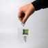 A hand holds a clear hotel keychain with a logo and a tag reading "Adelaide Manor." The keychain is transparent.