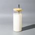 A drink bottle featuring a clear container with a white exterior and a wooden lid, complete with a metal straw.