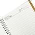 A spiral notebook with a brown cover, featuring blank lined pages and a section for notes and dates.