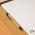 A brown folder contains lined paper and a black pen, with a recycling logo on the inside.