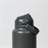 A drink bottle in a dark grey colour with a secure lid and a carrying strap. It features a logo on the body.