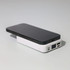 A black smartphone resting on a white Turbo 5000mAh wireless charging power bank with multiple ports.