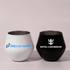 A set of two wine glasses, one white and one black, featuring different logos on each.