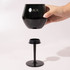 A black Shiraz Detachable Wine Glass with a removable stem, featuring a logo on the cup.