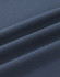 A close-up of dark navy blue cotton fabric, showcasing its smooth texture and folds.