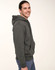 A man wearing a grey adult's close front contrast fleecy hoodie with a front pocket and a hood.