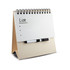 A whiteboard notepad with a spiral binding and a black marker, resting on a beige stand.