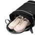 A black High Sierra travel backpack with grey accents, featuring a compartment holding a pair of white sneakers.