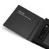 A black power bank housed in a sleek box, featuring a USB cable and branding.
