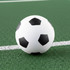 A high bounce soccer ball featuring a classic black and white design, resting on a green surface.