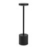 A black rechargeable table lamp with a cylindrical base and a flat, circular top. It features a simple, modern design.