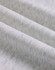 A close-up of soft, grey fabric showing a textured, fleece surface with subtle variations.