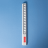 A white popper ruler featuring multiple poppers along its length and a small logo.