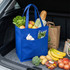 A blue shopping bag filled with lettuce, apples, bread, vegetables, and other groceries in a car boot.