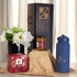 A blue drink bottle, a jar, a box, and a vase with flowers arranged on brown packaging.