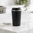 A drink bottle with a sleek black exterior and a stainless steel rim, featuring a lid and a logo.