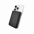 A black power bank is attached to the back of a smartphone, highlighting its sleek design. The product includes branding.