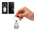 A silver rectangular keytag held in a hand, displayed in a black gift box. The keytag features a logo.