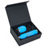 A black magnetic gift box containing two blue drink bottles with silver accents, resting on shredded black paper.