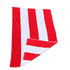A red and white striped cotton beach towel, folded partially to show its texture. It has a logo on one corner.