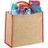 A large jute tote in natural colour with red trim, filled with a drink bottle, magazines, sunglasses, and a towel.