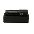 A black LED torch featuring a textured grip and a button, placed on a black box.