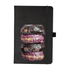 A black journal featuring an image of three decorative doughnuts on the cover. The journal includes an elastic band.