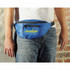 A blue bum bag with a front zip pocket and a logo is worn around the waist of a person.
