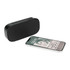 A black Bluetooth speaker next to a smartphone displaying music playback, featuring a logo on the speaker.