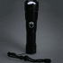 A black LED flashlight with a textured grip and a lanyard, featuring a circular button on its body.