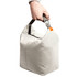 A hand holds a light grey cooler bag with a sturdy handle and a clip attachment.