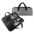 A BBQ set with metal tools including a spatula, fork, knife, and tongs, contained in a grey carrying case.