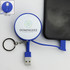 A blue charging cable key ring with a retractable USB connector, attached to a smartphone. It features a logo on the front.