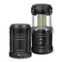 A black COB lantern with a transparent casing and two adjustable handles, showcasing its compact design.