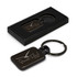 A black key ring with a rectangular tag in a box, featuring a branding logo on the tag.