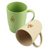 Two reusable bamboo mugs in green and beige, featuring a simple logo on the front of each.