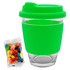 A green Carlo glass coffee cup with a silicone sleeve, accompanied by a bag of colourful jelly beans.